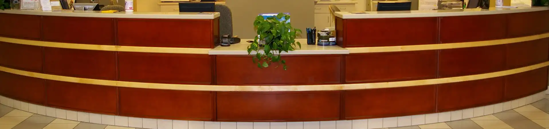 Photo of receptionists desk with newly refinished wood panels