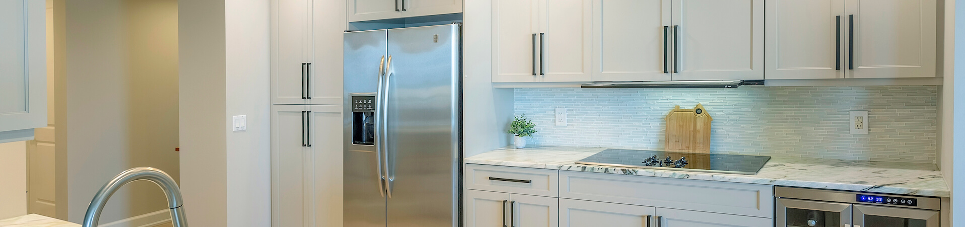 Photo of kitchen with blue and white refinished cabinets