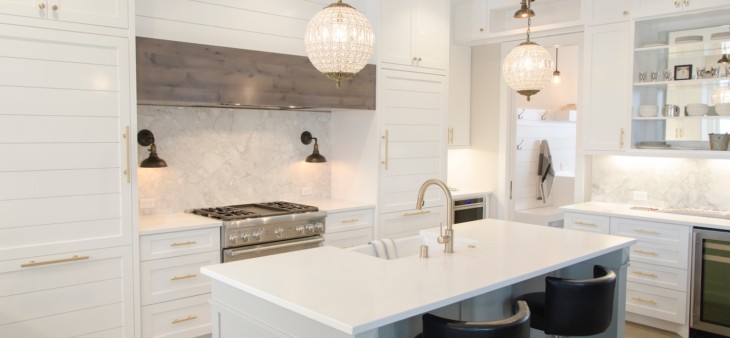 white kitchen cabinets with large pendant lights
