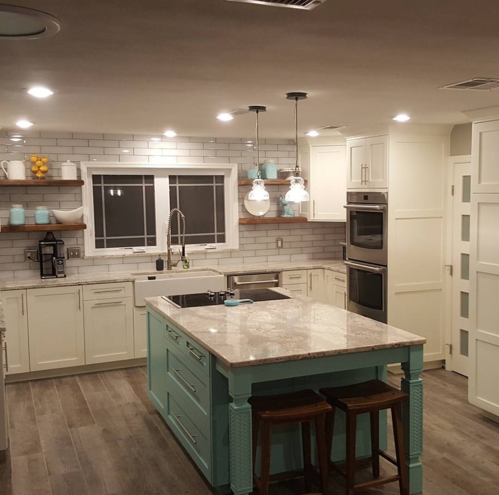 accent color on kitchen island with white wall cabinets