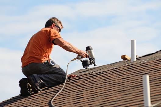 roofer installing shingles