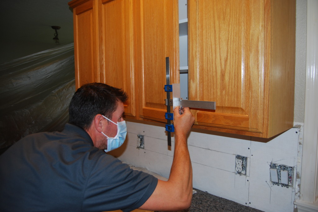 nhance of boise tech using a jig to drill holes in cabinets