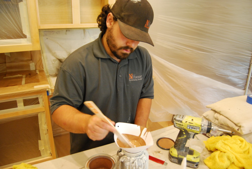 a technician mixing a cabinet paint stain