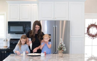 mother and daughters cooking in kitchen