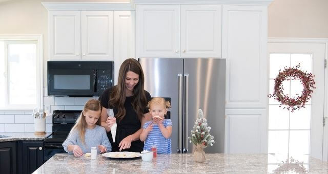 mother and daughters cooking in kitchen