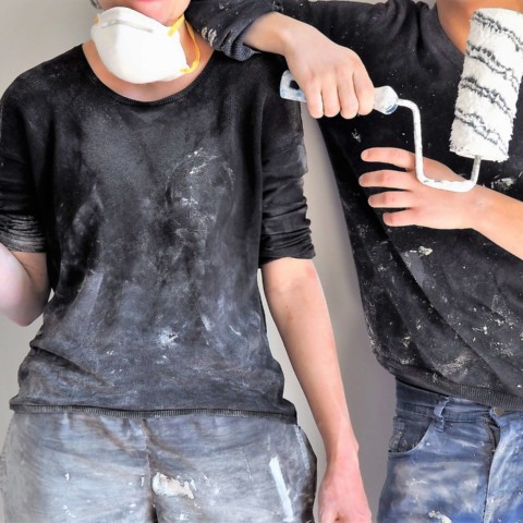 people holding roller paint brushes