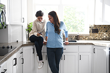 Mom and daughter in white kitchen