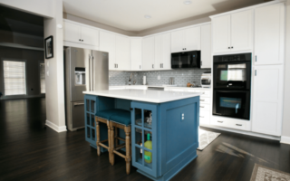 kitchen with white cabinets and blue island