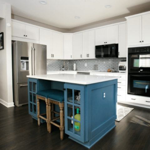 kitchen with white cabinets and blue island