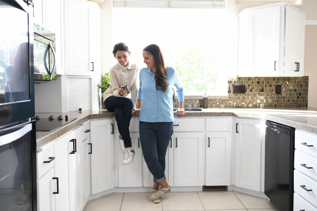 mom and daughter enjoying painted kitchen cabinets jacksonville beach