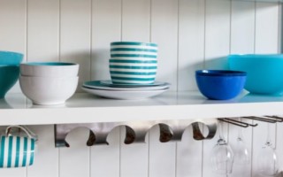 blue dishes on white open shelf cabinets