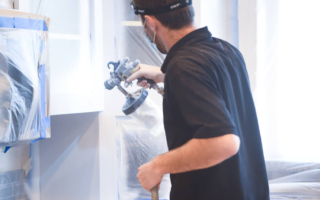 N-Hance technician using cabinet painting equipment