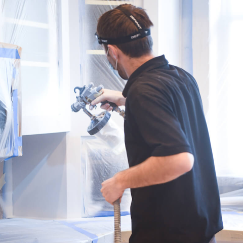 N-Hance technician using cabinet painting equipment