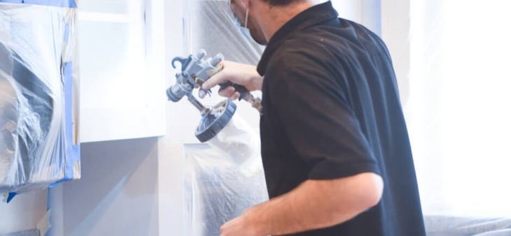 N-Hance technician using cabinet painting equipment