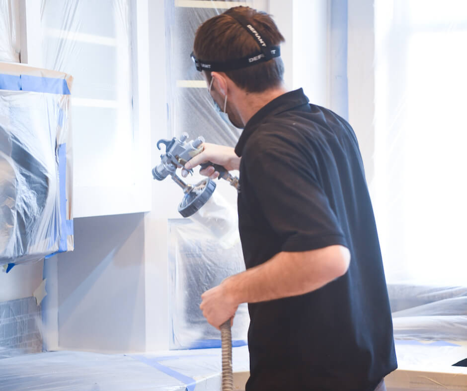 N-Hance technician using cabinet painting equipment
