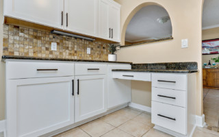 white kitchen cabinet with upgraded hardware