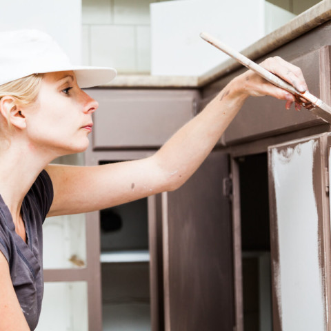 woman painting cabinets