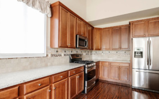 Kitchen with light wooden cabinets