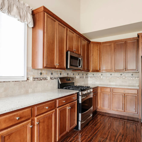 Kitchen with light wooden cabinets