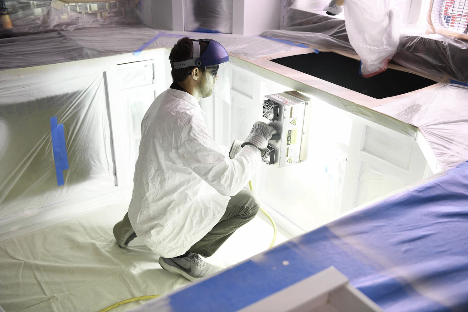 Technician using Lightspeed to cure cabinets