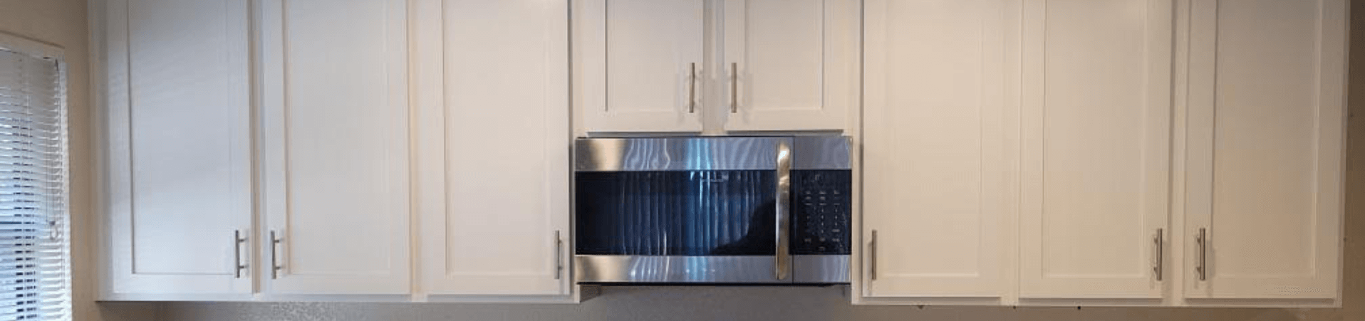 Photo of kitchen with blue and white refinished cabinets