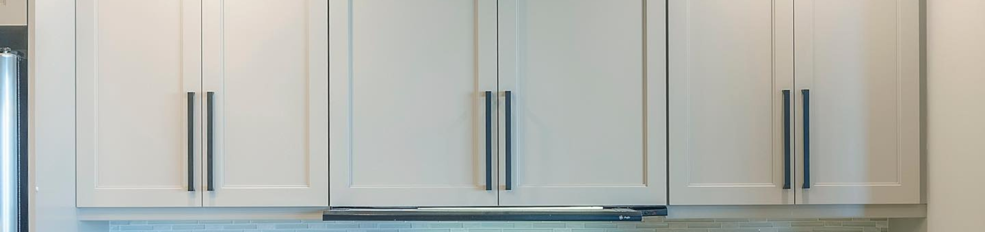 Photo of kitchen with blue and white refinished cabinets