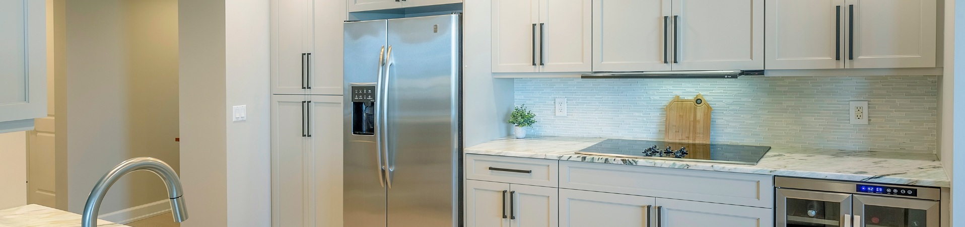 Photo of kitchen with blue and white refinished cabinets