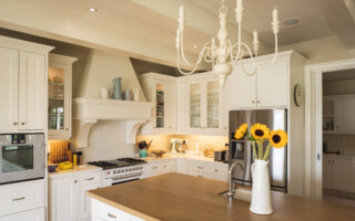 why interior designers like working with N-Hance blog feature image - clean white kitchen with sunflowers on the counter