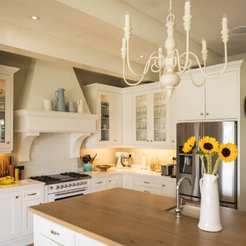why interior designers like working with N-Hance blog feature image - clean white kitchen with sunflowers on the counter
