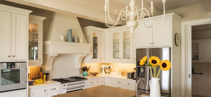 why interior designers like working with N-Hance blog feature image - clean white kitchen with sunflowers on the counter