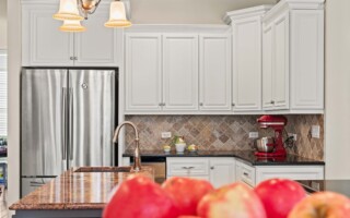 white kitchen cabinets with red wall
