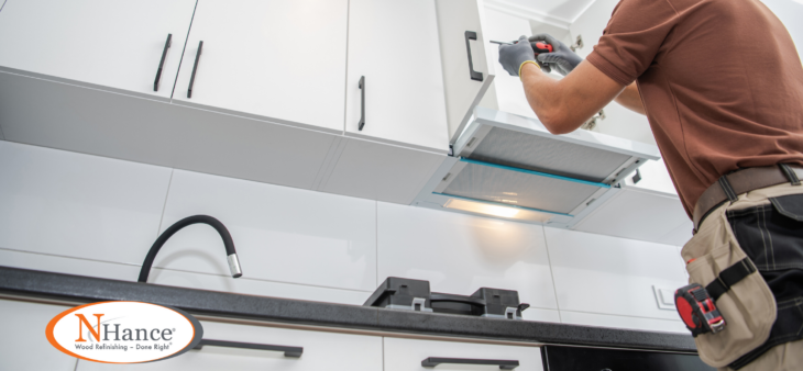 man installing cabinet hardware NHance logo