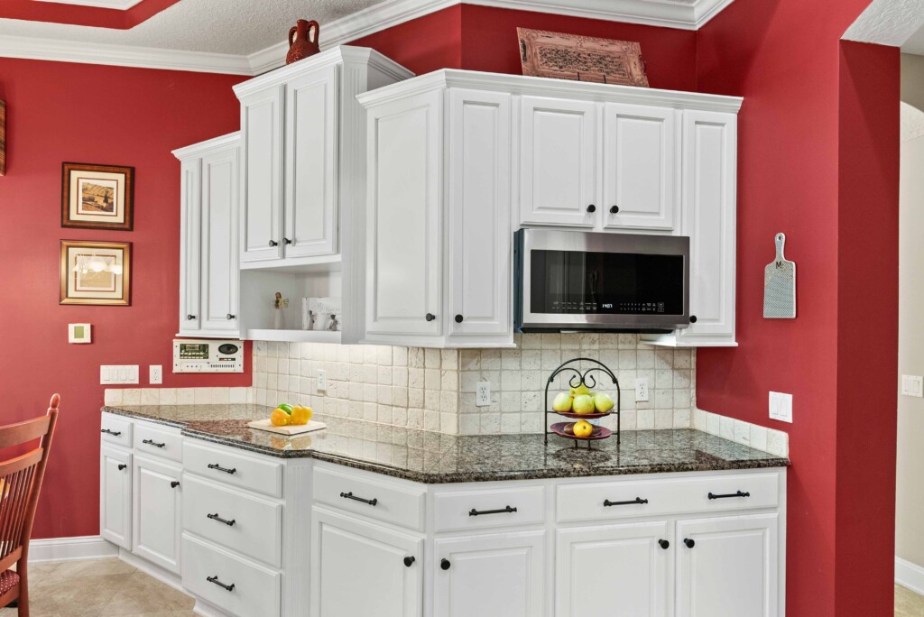 red walled kitchen with white painted cabinets in milton ga