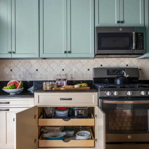 Kitchen with light blue overhead cabinets and beige lower cabinets