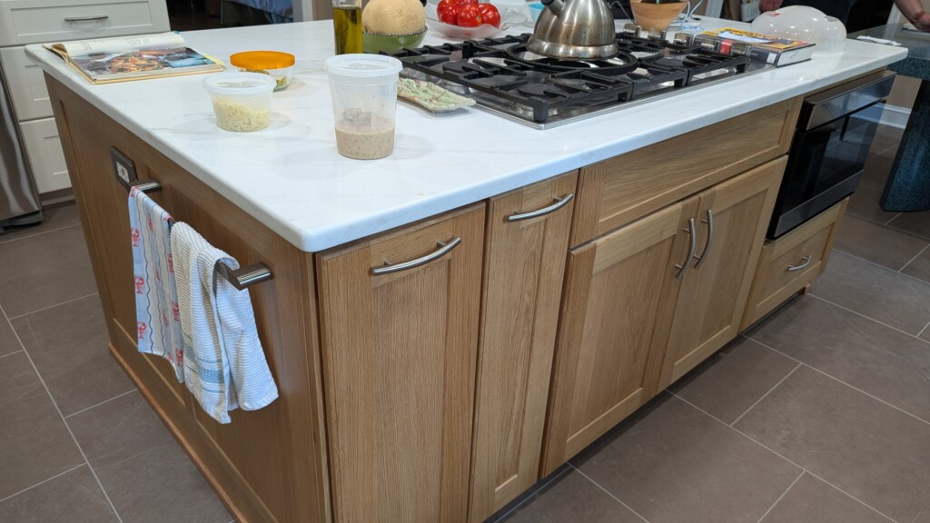 kitchen island that has storage, pull outs, microwave