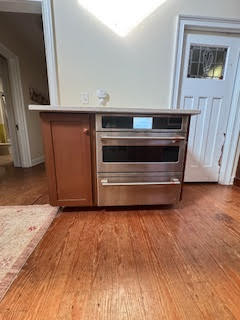 stand alone cabinet that needs to be refinished. there is an oven next to the cabinet