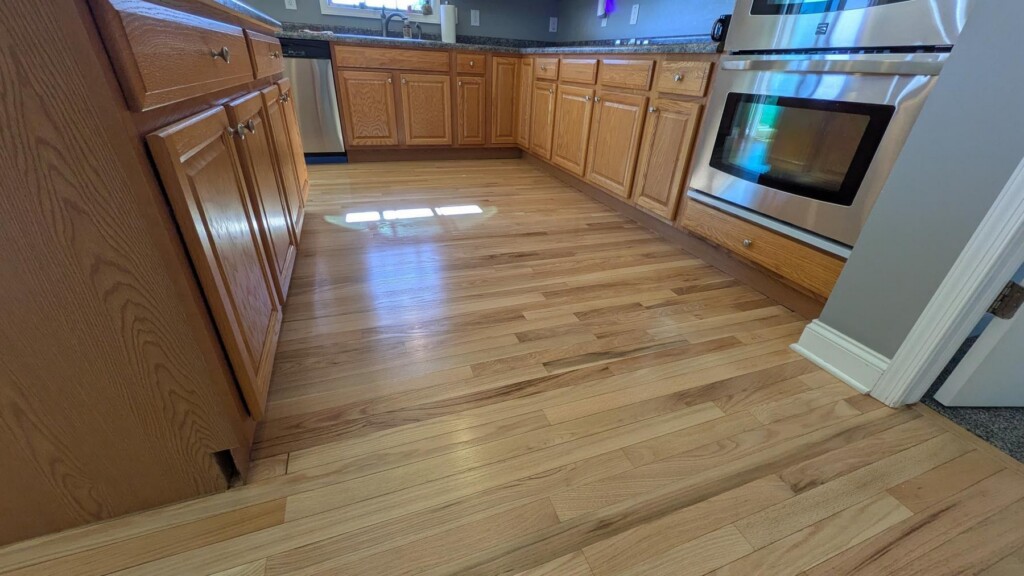 hardwood floors after refinishing in kitchen in front of oven