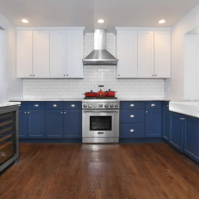 Photo of kitchen with blue and white refinished cabinets